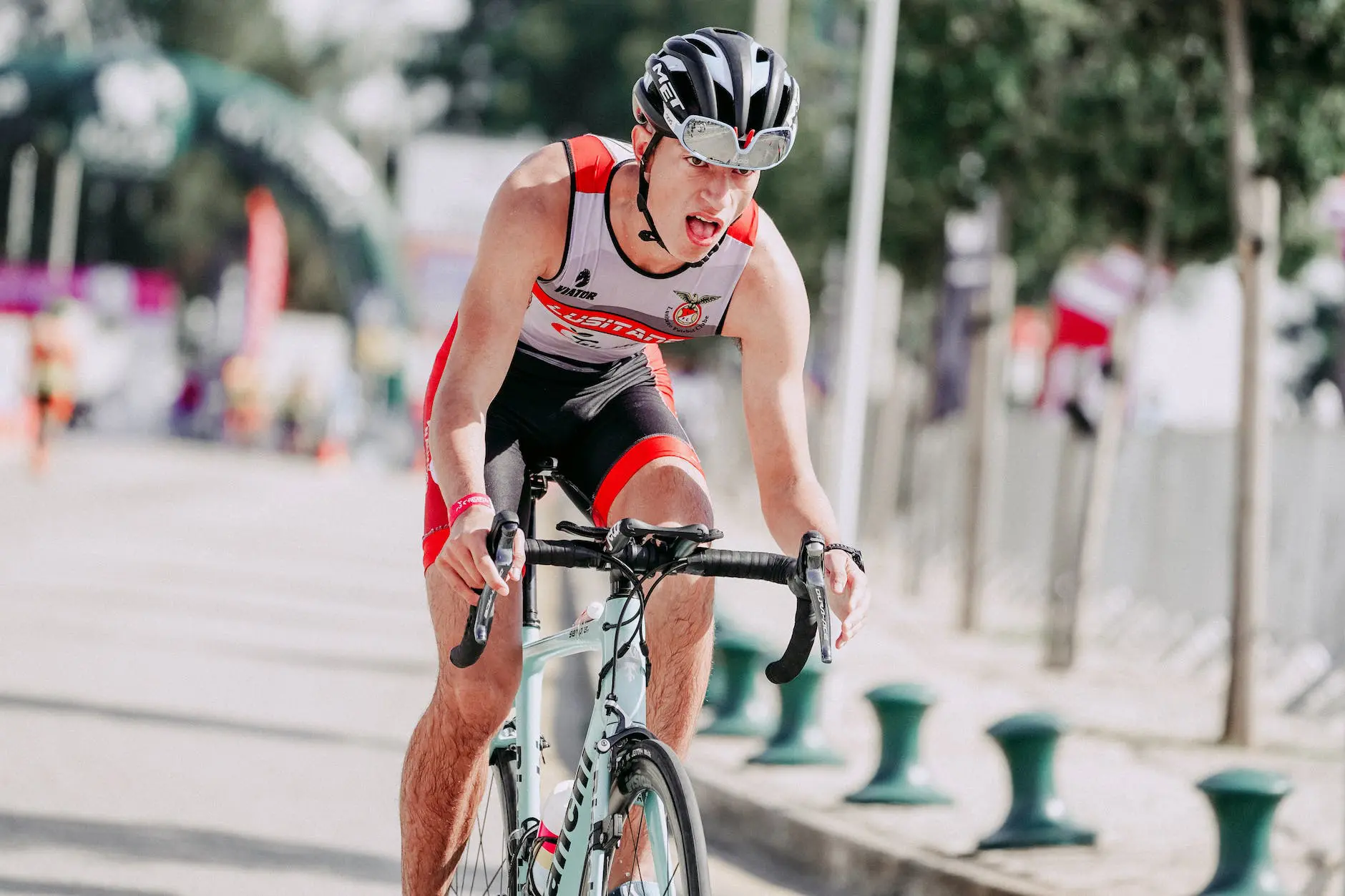 focused cyclist riding bike during competition in town