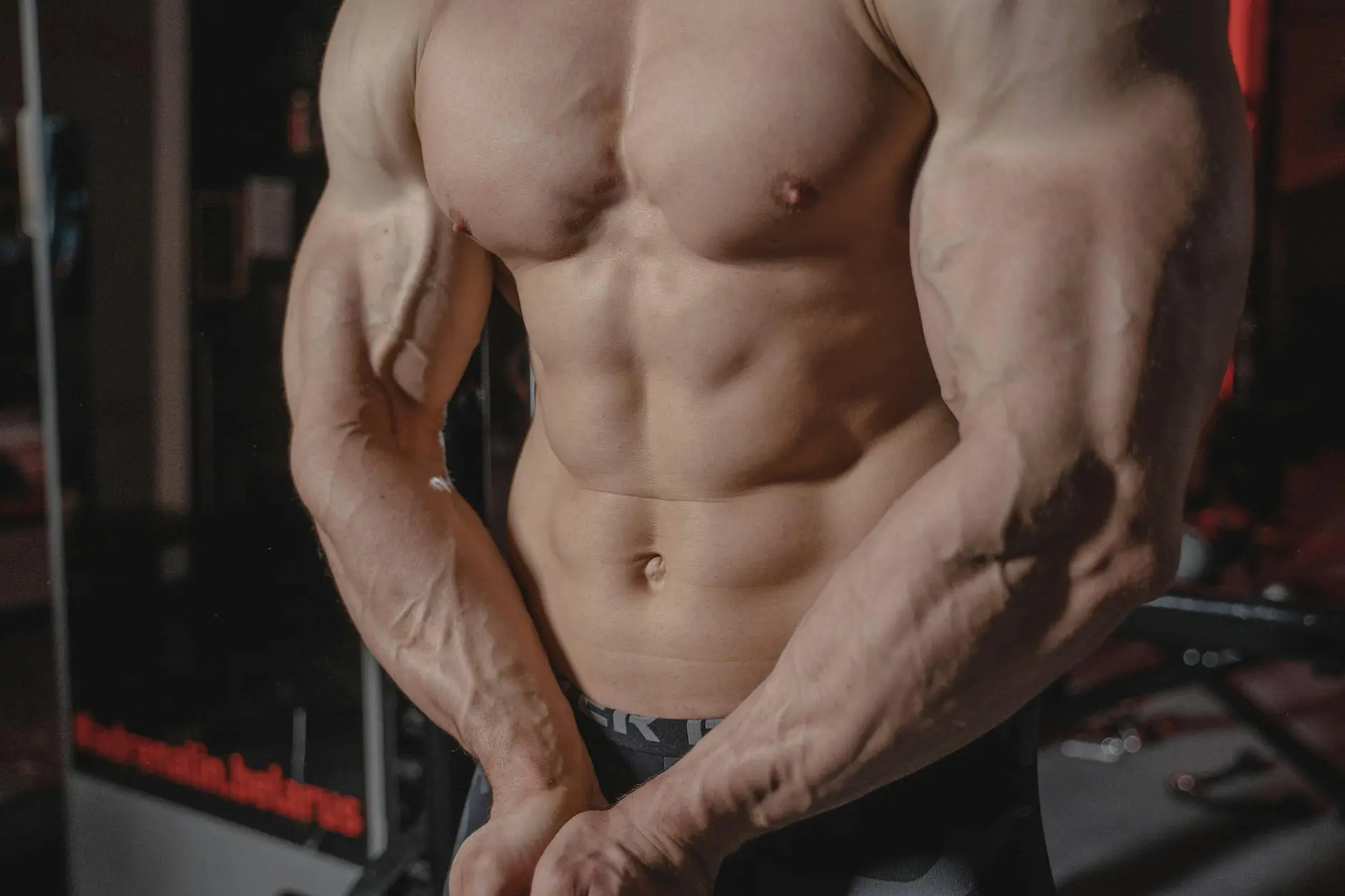 topless man flexing his muscles